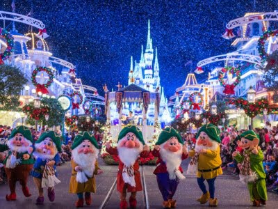 Dressed in their holiday finest, the Seven Dwarfs parade down Main Street, U.S.A., at Magic Kingdom during 